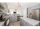 Open concept kitchen features stainless steel appliances, grey cabinets, and granite countertops at 8718 Canter Post Dr, Charlotte, NC 28216