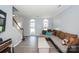 Comfortable living room showcasing a spacious sectional sofa, arched windows, and staircase, with a relaxing atmosphere at 8718 Canter Post Dr, Charlotte, NC 28216