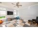 Living area features a ceiling fan, large windows, and playroom floor at 8718 Canter Post Dr, Charlotte, NC 28216