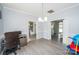 Bright room used as office, features desk, chair, shelves and laminate floors. Next to the room is a kitchen at 8718 Canter Post Dr, Charlotte, NC 28216