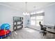 Cozy office space featuring a desk, chair, shelving unit, and natural light, creating a productive work environment at 8718 Canter Post Dr, Charlotte, NC 28216