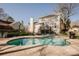 The backyard features a sparkling swimming pool, surrounded by a concrete patio, perfect for relaxing and entertaining at 8718 Canter Post Dr, Charlotte, NC 28216