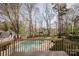 Inviting backyard featuring a sparkling swimming pool with a surrounding deck and a well-maintained lawn at 8718 Canter Post Dr, Charlotte, NC 28216