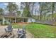 Spacious backyard with a cozy fire pit area, seating, and lush greenery at 9025 Shields Dr, Huntersville, NC 28078