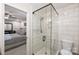 Modern bathroom with a glass-enclosed shower featuring white subway tile and a view into the bedroom at 9025 Shields Dr, Huntersville, NC 28078