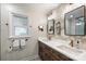 Elegant bathroom features dual sinks, updated fixtures, decorative wall paper and a patterned floor at 9025 Shields Dr, Huntersville, NC 28078