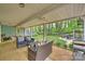 Inviting covered patio with comfortable seating, ceiling fans, overlooking a spacious backyard at 9025 Shields Dr, Huntersville, NC 28078