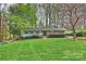 Beautiful single-story home with lush landscaping, flowering trees, and a well-maintained lawn at 9025 Shields Dr, Huntersville, NC 28078