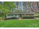 Charming single story home with manicured lawn, mature trees, and inviting front entrance at 9025 Shields Dr, Huntersville, NC 28078