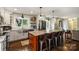 Modern kitchen with stainless steel appliances, center island with barstool seating, and hardwood floors at 9025 Shields Dr, Huntersville, NC 28078