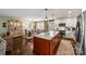 Spacious kitchen and dining area featuring an island with marble countertop and hardwood floors at 9025 Shields Dr, Huntersville, NC 28078
