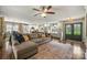Open-concept living room with a large sectional sofa, hardwood floors, and access to the kitchen at 9025 Shields Dr, Huntersville, NC 28078