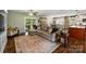 A spacious living room features a sectional sofa, patterned rug, and sliding door access to the patio at 9025 Shields Dr, Huntersville, NC 28078