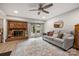 Cozy living room with a brick fireplace, ceiling fan, and stylish rug at 9025 Shields Dr, Huntersville, NC 28078