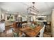 A cozy living and dining area features hardwood floors, a rustic wood dining table, and a modern island kitchen at 9025 Shields Dr, Huntersville, NC 28078