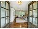 Inviting living room with hardwood floors, a comfortable sectional, and doors opening to the backyard at 9025 Shields Dr, Huntersville, NC 28078