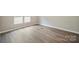 A bright bedroom with laminate flooring and wainscoting with multiple electrical outlets at 102 Lansdale Ave, Lincolnton, NC 28092