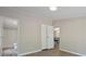 Bedroom with updated floors, neutral paint, and two closets leading to bathroom and dining areas at 102 Lansdale Ave, Lincolnton, NC 28092
