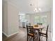 Bright dining area with a round table, four chairs, a chandelier, and view to the kitchen at 102 Lansdale Ave, Lincolnton, NC 28092