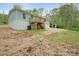 Rear view of home with a deck and stairs leading to the ground, with a small outbuilding in the yard at 102 Lansdale Ave, Lincolnton, NC 28092