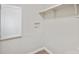 A simple laundry room area with a storage shelf and utility connections at 102 Lansdale Ave, Lincolnton, NC 28092