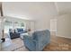 Inviting living room featuring a cozy fireplace, comfortable blue sofas, and a bright, open layout with hardwood floors at 102 Lansdale Ave, Lincolnton, NC 28092