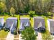 Aerial view of charming homes boasting well-manicured lawns and mature trees, offering a serene neighborhood setting at 10441 Hugue Way, Charlotte, NC 28214