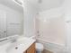 Bright bathroom features tub and shower combination and wooden vanity at 10441 Hugue Way, Charlotte, NC 28214