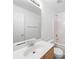 Well-lit bathroom with single sink vanity and a tub with shower at 10441 Hugue Way, Charlotte, NC 28214