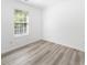 This bedroom features neutral walls, updated floors, and a sun-filled window at 10441 Hugue Way, Charlotte, NC 28214