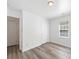 This bedroom features neutral walls, updated floors, a large closet, and a sun-filled window at 10441 Hugue Way, Charlotte, NC 28214