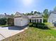 Charming single-story home with white siding, well-maintained landscaping, and an attached one-car garage at 10441 Hugue Way, Charlotte, NC 28214