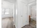 Hallway view showcasing an open doorway to a bathroom and ample natural light at 10441 Hugue Way, Charlotte, NC 28214