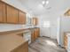 Kitchen features light wood cabinets, stainless sink, white appliances, and new laminate flooring at 10441 Hugue Way, Charlotte, NC 28214