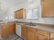 Kitchen features light wood cabinets, stainless sink, white appliances, and new laminate flooring at 10441 Hugue Way, Charlotte, NC 28214