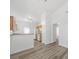 Bright kitchen features light wood cabinets, white appliances, and new laminate flooring at 10441 Hugue Way, Charlotte, NC 28214