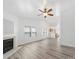Bright living room featuring a fireplace, ceiling fan, and neutral color palette, with views of kitchen at 10441 Hugue Way, Charlotte, NC 28214