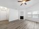 Inviting living room featuring a cozy fireplace, ceiling fan, and ample natural light at 10441 Hugue Way, Charlotte, NC 28214