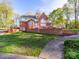 Spacious backyard features a well-manicured lawn, brick retaining wall, and a winding walkway at 106 Berea Baptist Church Rd, Stanfield, NC 28163