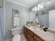 Well-lit bathroom featuring neutral wall paint, wood cabinets, and a decorative mirror at 106 Berea Baptist Church Rd, Stanfield, NC 28163