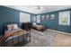 Stylish bedroom features blue walls, ceiling fan, two twin beds, and natural light at 106 Berea Baptist Church Rd, Stanfield, NC 28163
