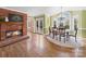 Cozy dining area with brick fireplace, hardwood floors, and arched windows providing natural light at 106 Berea Baptist Church Rd, Stanfield, NC 28163