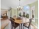 Bright dining room features a modern chandelier, large windows, and natural light with views of the landscaped yard at 106 Berea Baptist Church Rd, Stanfield, NC 28163