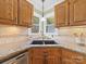 Kitchen featuring a granite countertop, stainless steel appliances, and an undermount sink with a garden view at 106 Berea Baptist Church Rd, Stanfield, NC 28163