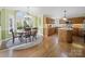 Eat-in kitchen with hardwood floors and breakfast nook features large windows with natural light and a granite island at 106 Berea Baptist Church Rd, Stanfield, NC 28163