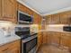 Bright kitchen with stainless steel appliances, oak cabinets, granite countertops and tiled backsplash at 106 Berea Baptist Church Rd, Stanfield, NC 28163