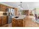 This kitchen with hardwood floors, stainless steel appliances, and oak cabinets opens to a dining area at 106 Berea Baptist Church Rd, Stanfield, NC 28163