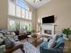 Living room with high ceilings, bright windows, hardwood floors, comfortable seating, and a fireplace at 106 Berea Baptist Church Rd, Stanfield, NC 28163
