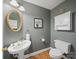 Stylish powder room boasts a pedestal sink, gold finishes, and a decorative mirror at 106 Berea Baptist Church Rd, Stanfield, NC 28163