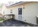 A back porch with a light hanging above the door and a wooden deck at 11100 Pine Grove Ave, Mint Hill, NC 28227